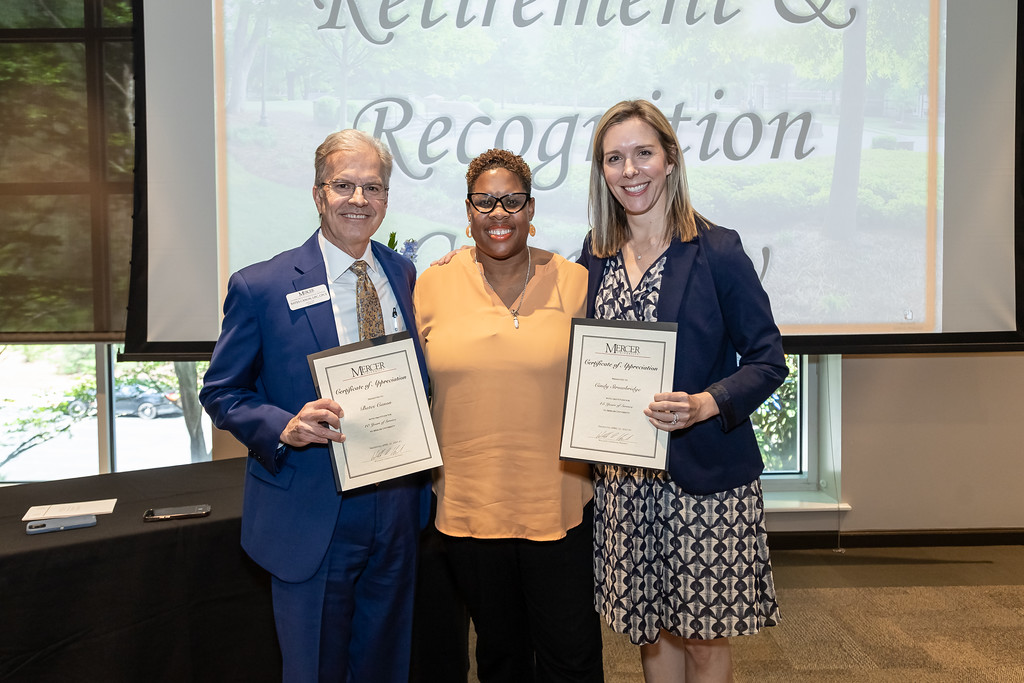 Penny Elkins and Chief Gary Collins hug at Mercer's Retirement and Recognition Ceremony