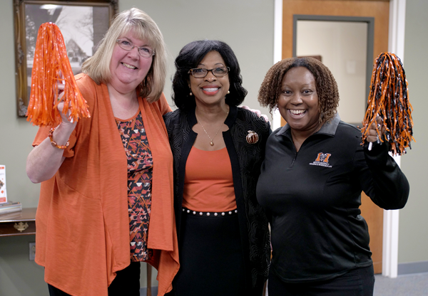 Faculty member looks over a student's shoulder
